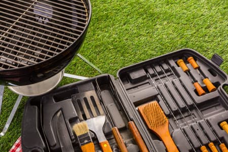 Stainless steel barbecue cooking set with wood handles.